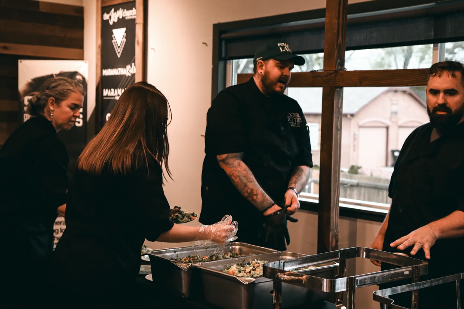 Come to the Table staff serving guests at a buffet line