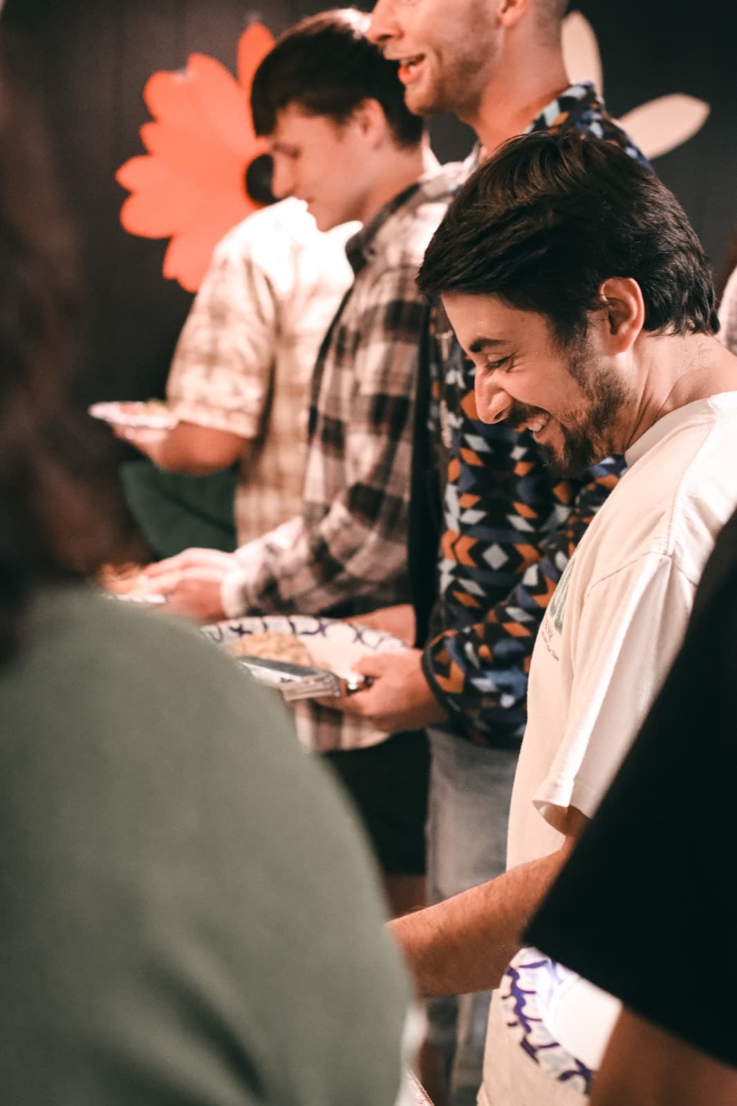Guests laughing together in the buffet line